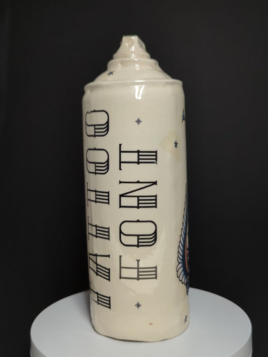 video of ceramic spray rotating on base, can is by Adam Graddon, spraycan is cream ceramic with tattoo text 