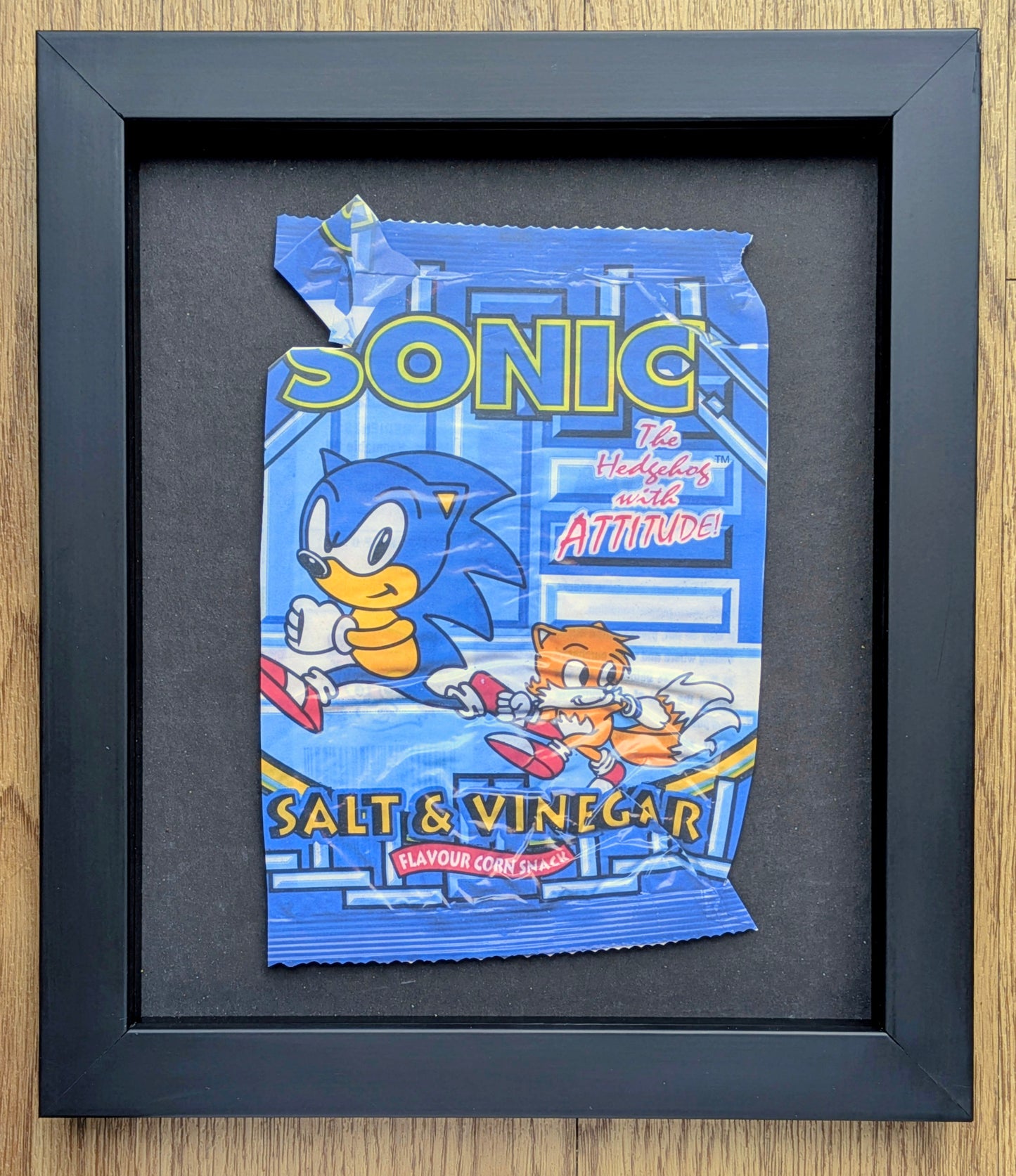 Framed artwork of Sonic the Hedgehog salt and vinegar snack packaging