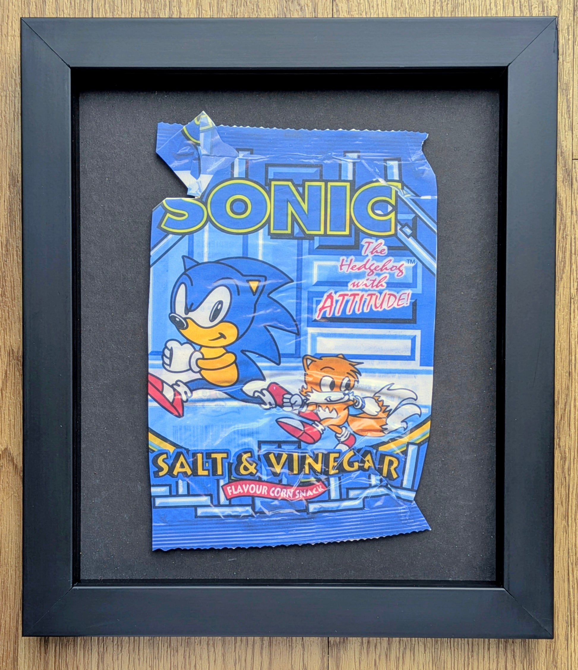 Framed artwork of Sonic the Hedgehog salt and vinegar snack packaging