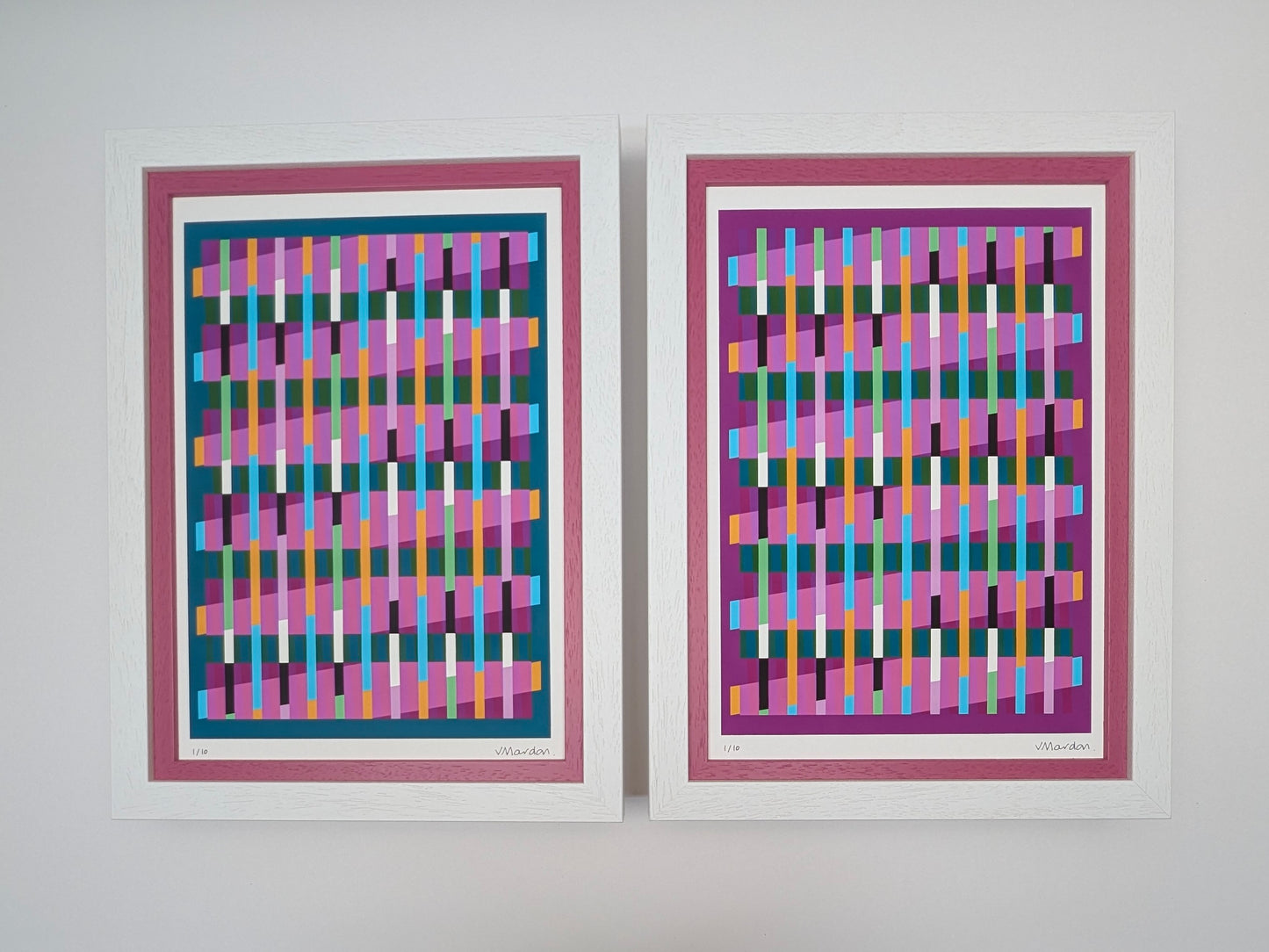 Two framed abstract artworks with colorful geometric patterns on a white wall.