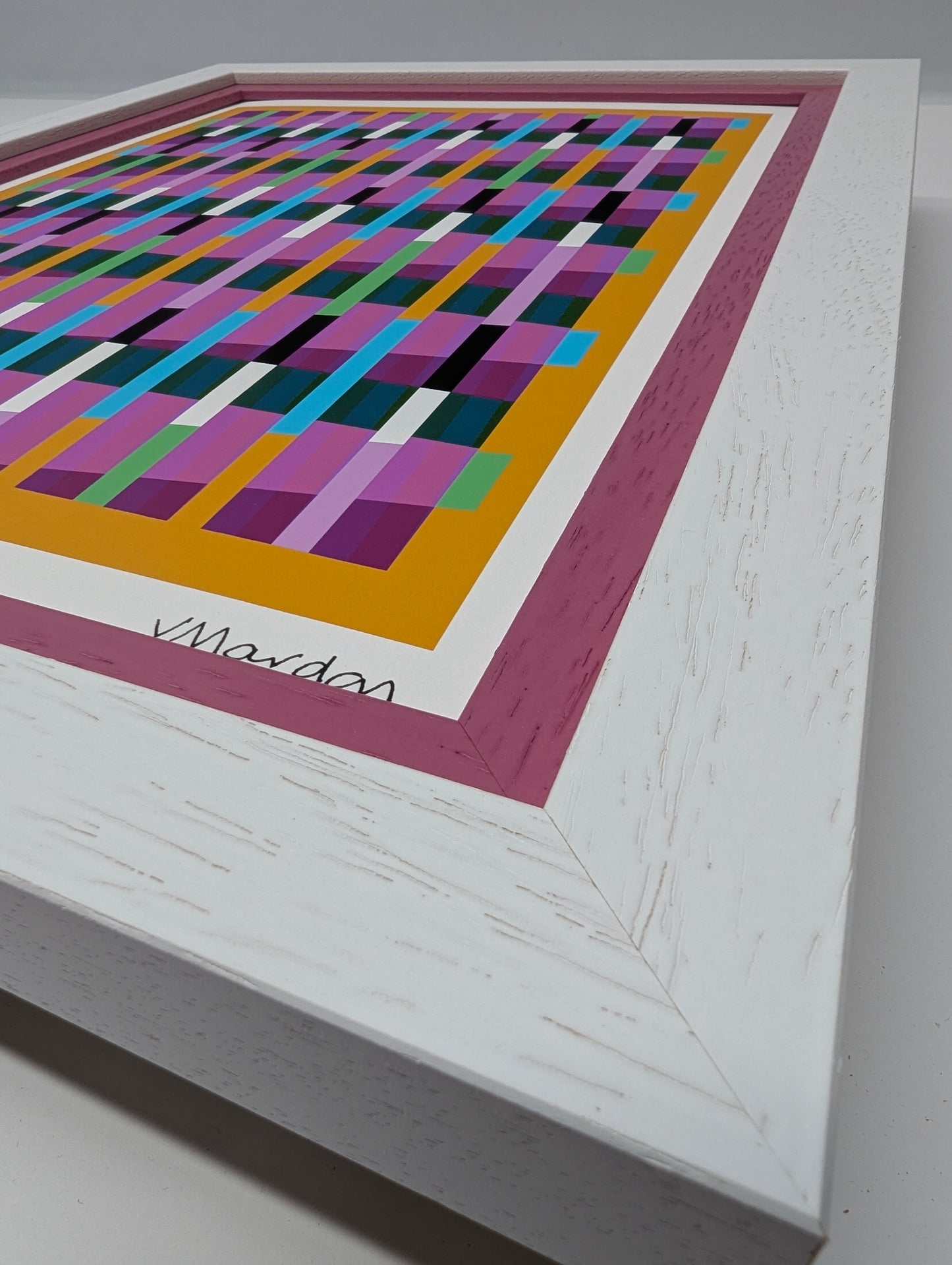 Framed abstract artwork with geometric pattern on a white background