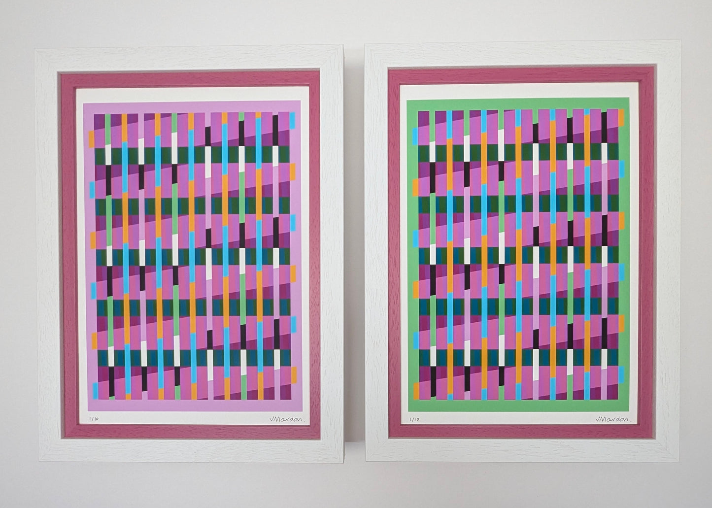 Two abstract art prints with colorful geometric patterns in pink frames on a white background.
