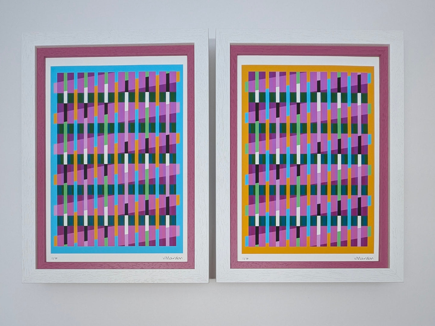 Two abstract art prints with colorful geometric patterns on a white wall.