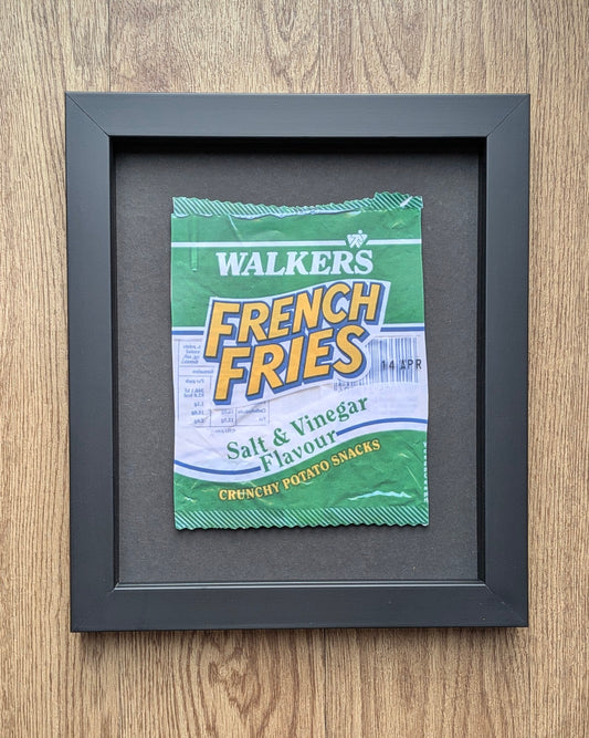 Framed Walkers French Fries salt & vinegar flavor packet on a wooden surface